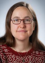 photo of Katelyn Browne, a white librarian with glasses and long brown hair